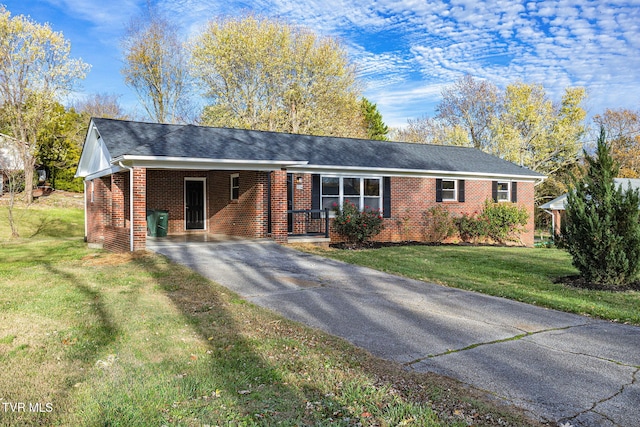 ranch-style house with a carport and a front lawn