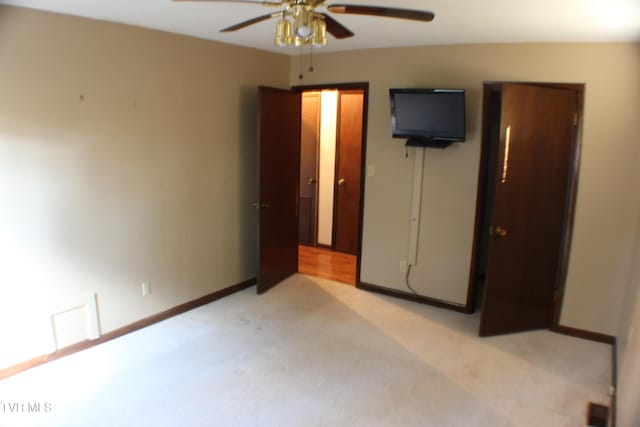 unfurnished bedroom featuring ceiling fan and light colored carpet