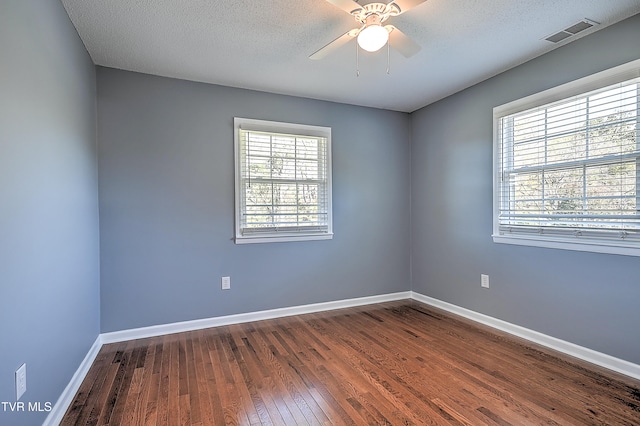 unfurnished room with hardwood / wood-style floors, ceiling fan, and a textured ceiling