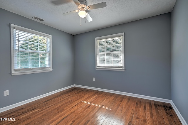 empty room featuring hardwood / wood-style floors, ceiling fan, and a textured ceiling