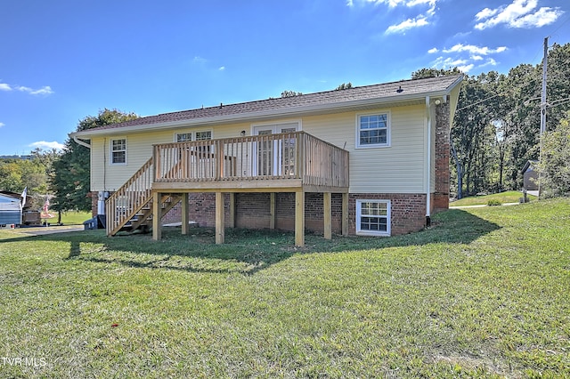 rear view of house with a yard and a wooden deck