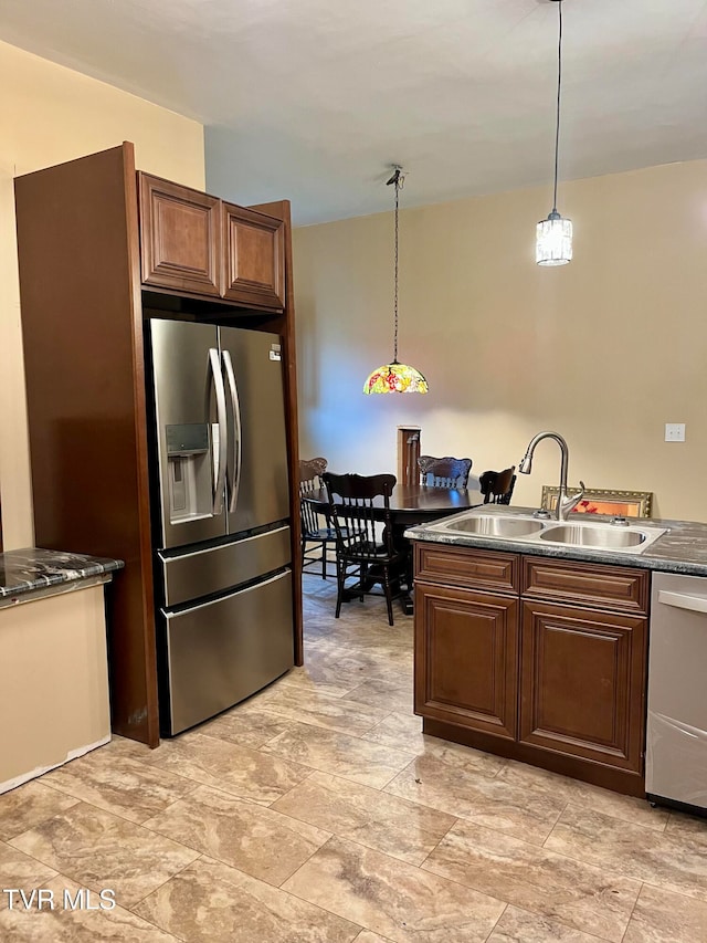 kitchen featuring appliances with stainless steel finishes, pendant lighting, and sink