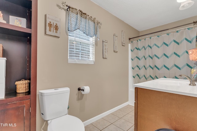 bathroom with tile patterned floors, vanity, a textured ceiling, and toilet