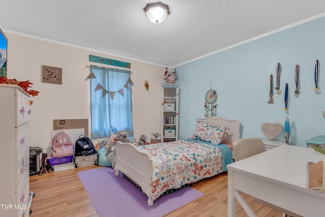 bedroom featuring crown molding, a textured ceiling, and light wood-type flooring