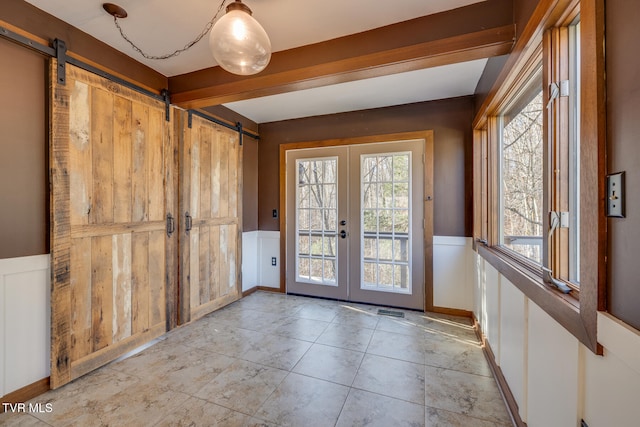 doorway to outside featuring french doors and a barn door