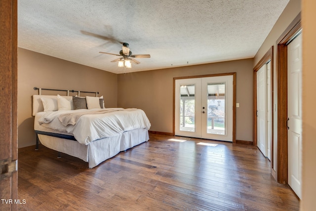 bedroom featuring a textured ceiling, ceiling fan, dark wood-type flooring, and french doors