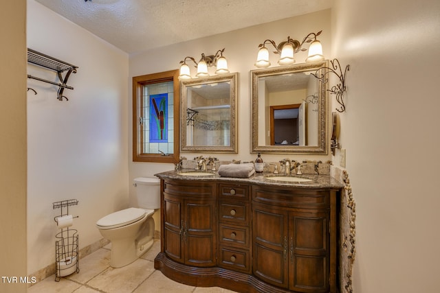 bathroom with vanity, tile patterned flooring, toilet, a textured ceiling, and walk in shower