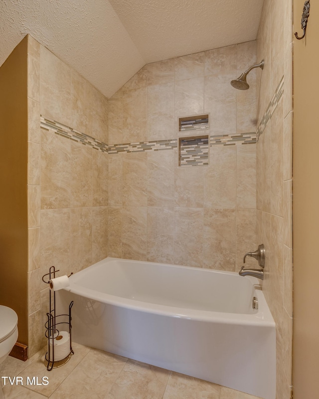 bathroom featuring tile patterned floors, a textured ceiling, and vaulted ceiling