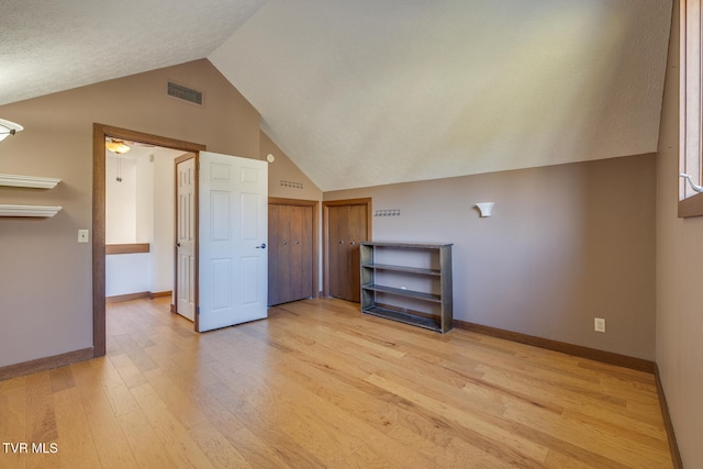 additional living space featuring ceiling fan, light hardwood / wood-style floors, and vaulted ceiling