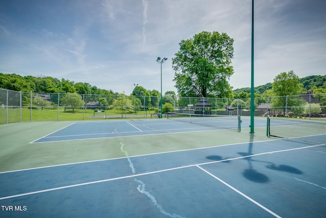 view of sport court featuring basketball hoop