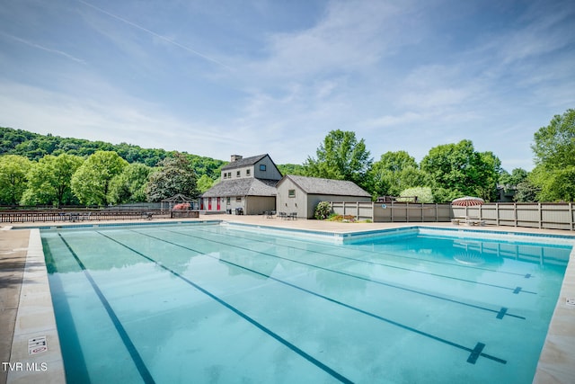 view of swimming pool with an outdoor structure