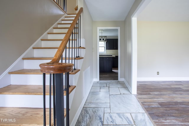 stairs featuring hardwood / wood-style flooring