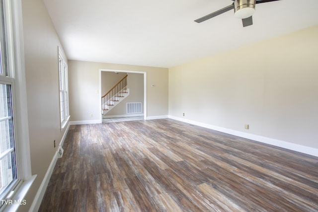 empty room with dark hardwood / wood-style floors and ceiling fan