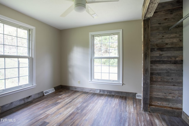 empty room featuring ceiling fan and dark wood-type flooring