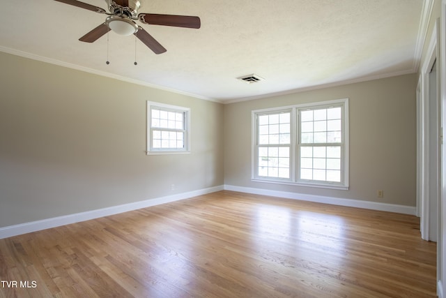 empty room featuring ceiling fan, light hardwood / wood-style floors, ornamental molding, and a textured ceiling