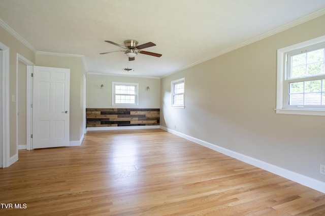 unfurnished room with ceiling fan, crown molding, and a wealth of natural light