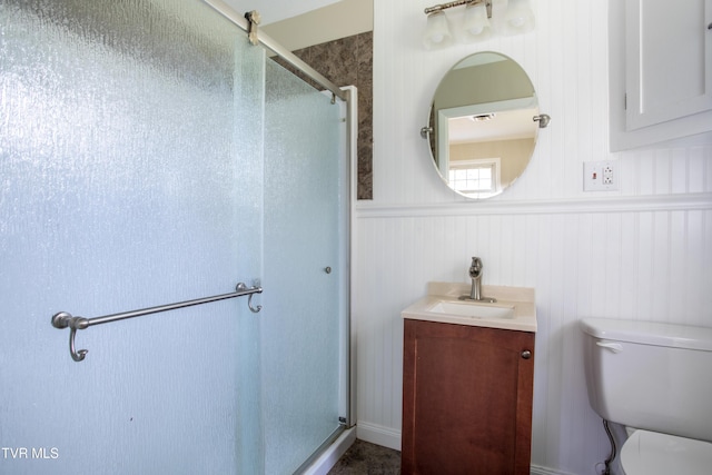 bathroom with vanity, an enclosed shower, and toilet