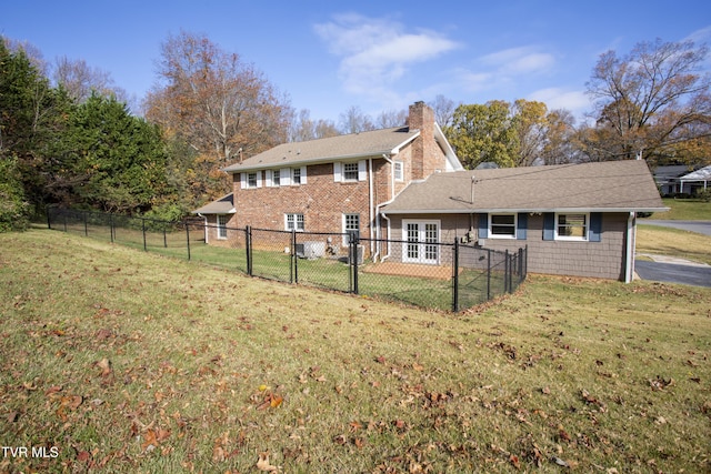 rear view of house with a yard