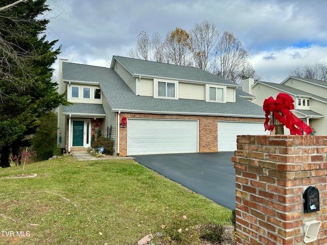 front facade featuring a front yard and a garage