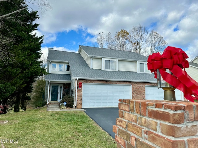 view of front of home with a garage and a front yard