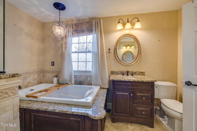 bathroom with vanity, a bathtub, tile patterned flooring, toilet, and a notable chandelier