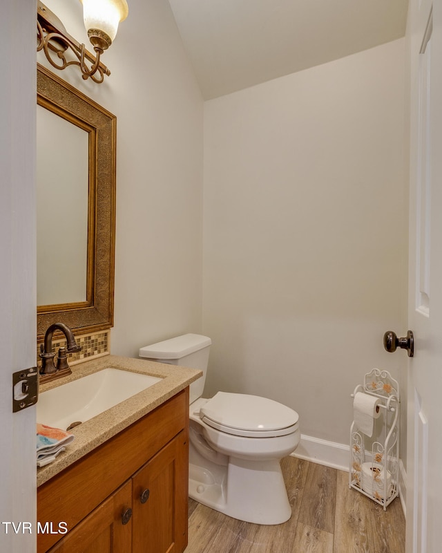 bathroom featuring hardwood / wood-style flooring, vanity, and toilet