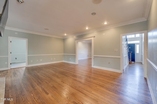 empty room featuring crown molding and hardwood / wood-style floors