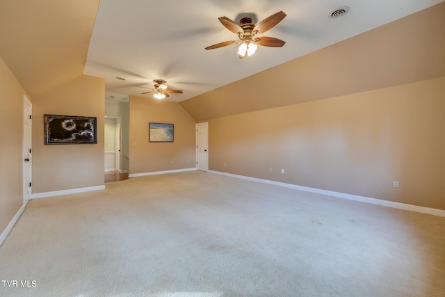 interior space with ceiling fan, light carpet, and lofted ceiling