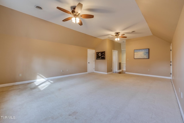 carpeted empty room featuring ceiling fan and vaulted ceiling