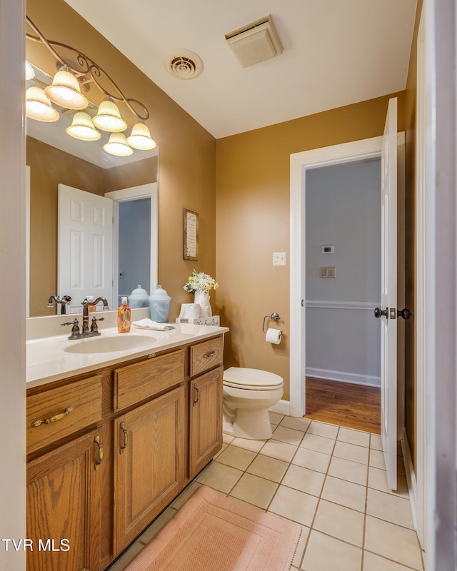 bathroom featuring tile patterned flooring, vanity, and toilet