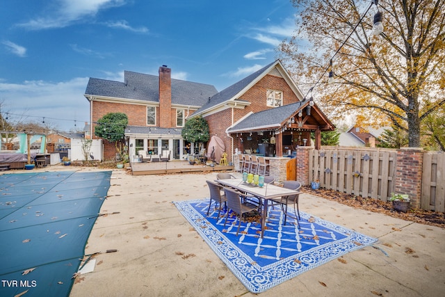 view of patio featuring exterior bar and a covered pool