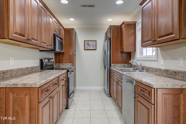 kitchen with light tile patterned flooring, stainless steel appliances, ornamental molding, and sink