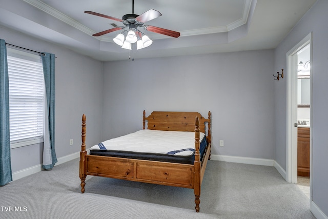 carpeted bedroom featuring a raised ceiling, ceiling fan, and crown molding