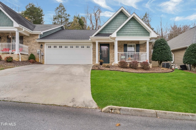 craftsman-style home featuring a porch, a garage, a front lawn, and cooling unit