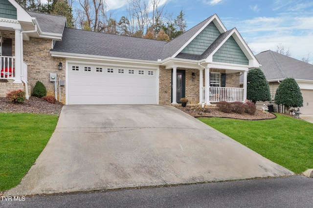 view of front of home featuring a front yard, a porch, and a garage