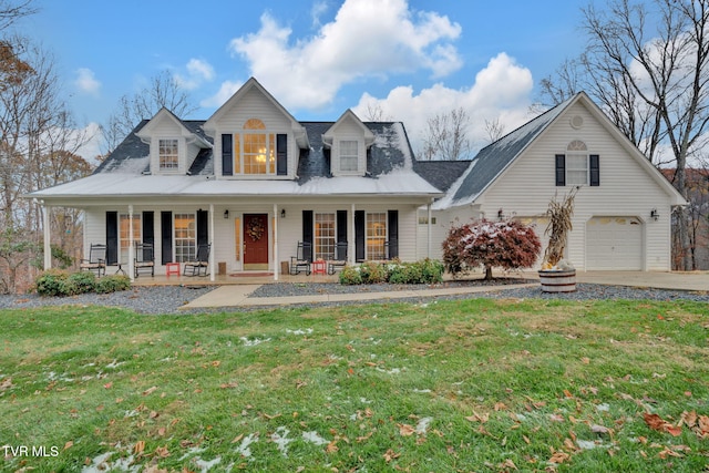 cape cod home featuring a porch, a garage, and a front yard