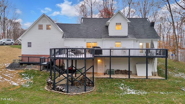 back of property featuring central air condition unit, a wooden deck, and a yard