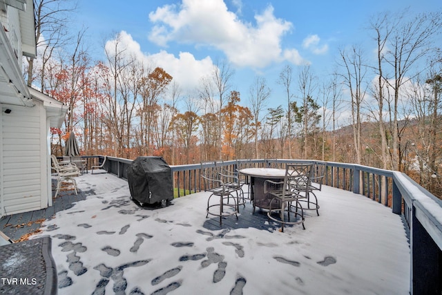 snow covered deck featuring area for grilling