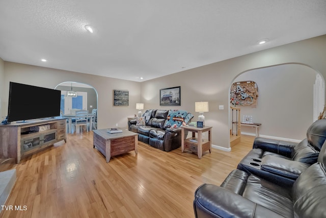 living room featuring light hardwood / wood-style floors and an inviting chandelier