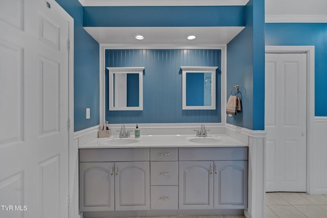 bathroom featuring tile patterned flooring, vanity, and ornamental molding