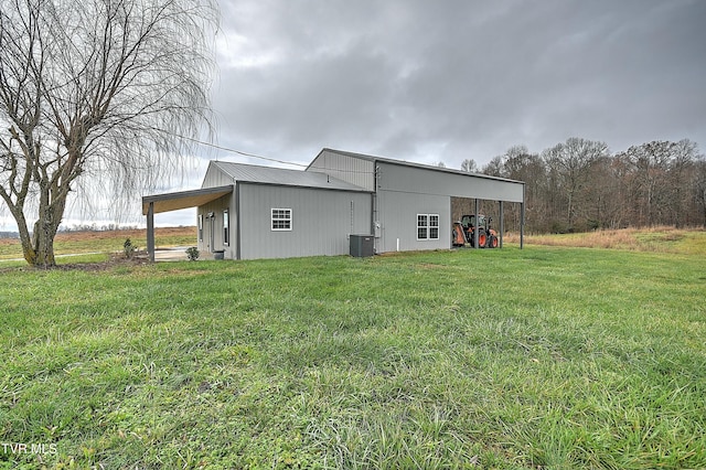 exterior space featuring a lawn and central air condition unit