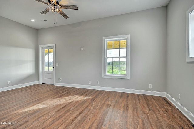 spare room featuring dark hardwood / wood-style flooring and ceiling fan