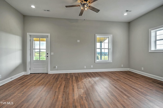 empty room featuring dark hardwood / wood-style flooring and ceiling fan