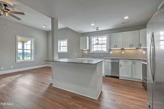 kitchen featuring pendant lighting, white cabinets, and appliances with stainless steel finishes