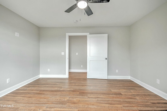 empty room with light hardwood / wood-style flooring and ceiling fan