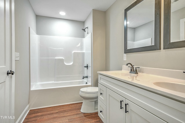 full bathroom featuring hardwood / wood-style flooring, vanity, toilet, and bathing tub / shower combination