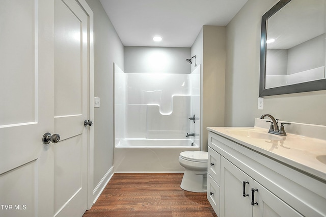 full bathroom with vanity, tub / shower combination, hardwood / wood-style floors, and toilet