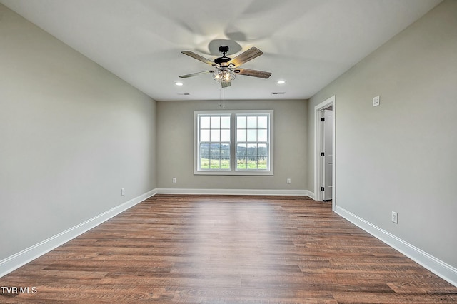 spare room with dark hardwood / wood-style floors and ceiling fan