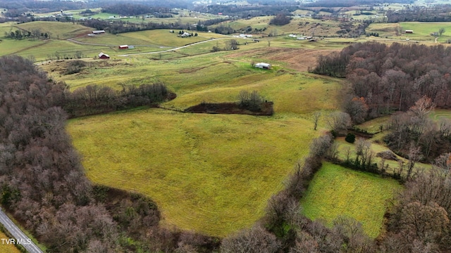 birds eye view of property with a rural view