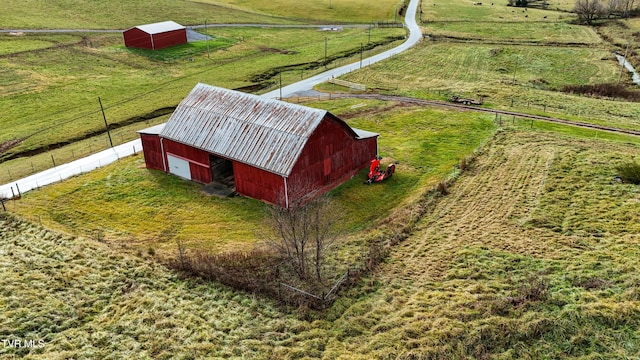 birds eye view of property with a rural view